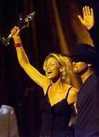 Tim and Faith salute the fans at the Country Award's